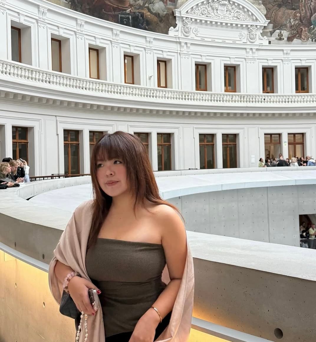 Isabella Ng standing in an ornate gallery