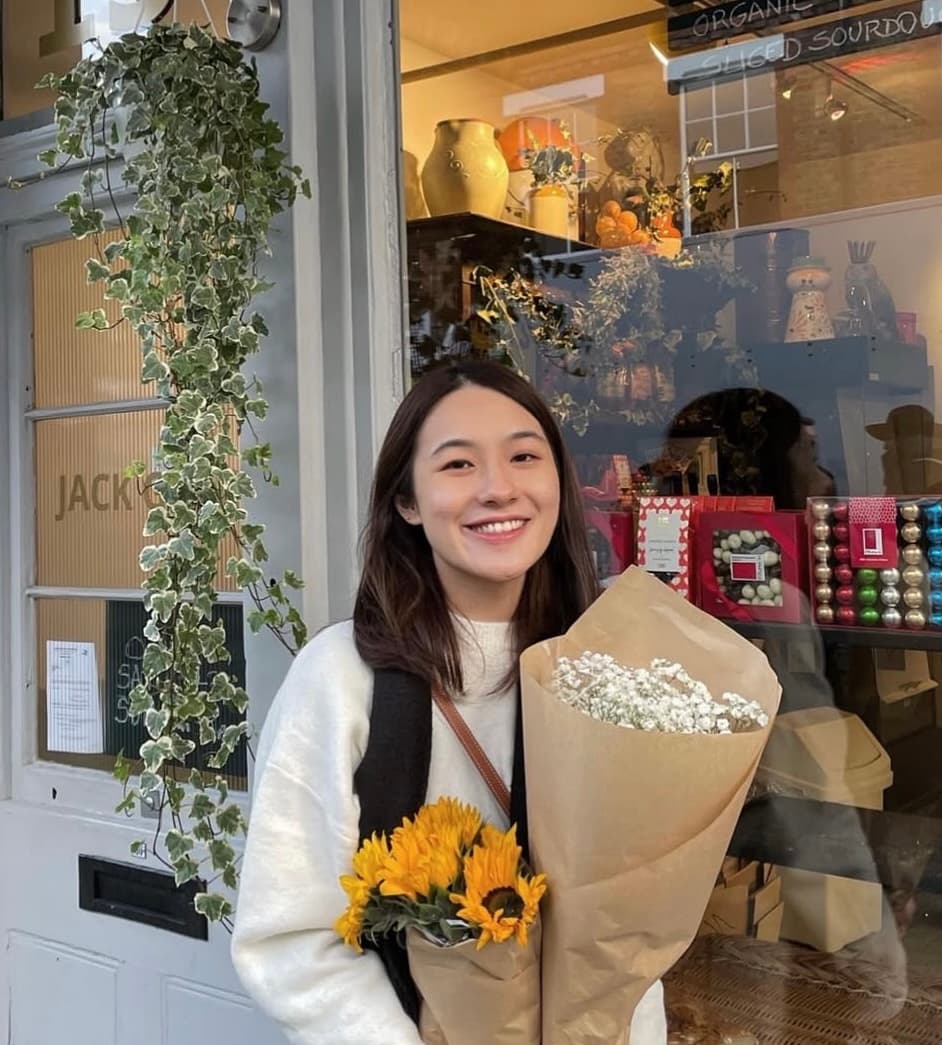 Teresa Lin holding a bouquet of sunflowers